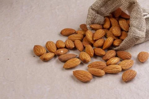 Almonds with in bag from sacking isolated on light background Foto stock