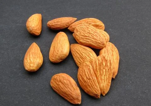Almonds on black background close-up view  Stock Photos