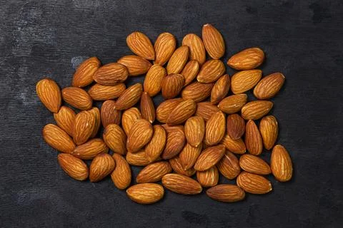 Almonds on a black background. Isolated almonds. Stock Photos