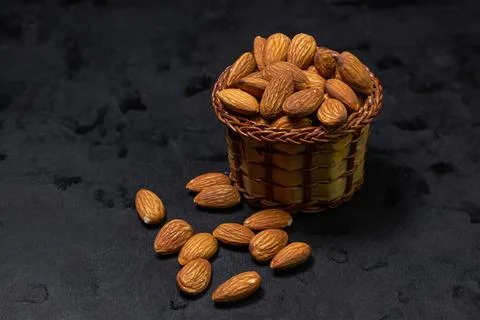 Almonds on a black background. Isolated almonds. Stock Photos