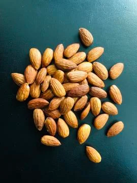 Almonds on black background Stock Photos