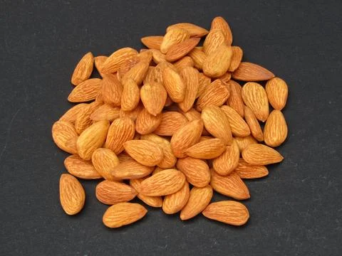 Almonds on black background  Stock Photos