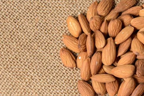 Almonds on a burlap background Stock Photos