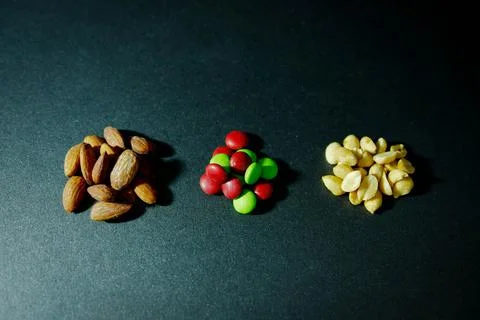 Almonds, candy, and peanuts Stock Photos