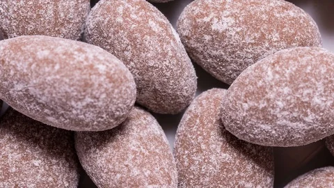 Almonds in chocolate candy textured background, stop motion Stock Footage 125973813