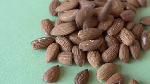 Almonds on a colored background. Stock Footage 341841120
