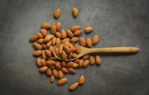 Almonds on dark background top view on the table, Close up roasted almond nut Stock Photos