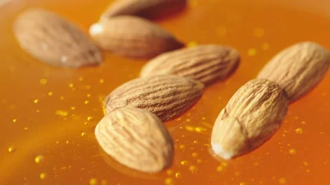 Almonds fall on honey Stock Footage 161077238