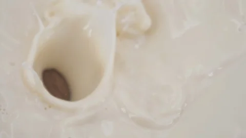 Almonds fall into milk in slow motion Stock-Footage 88800110