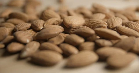 Almonds falling and rotating macro studio Stock Footage 101467471