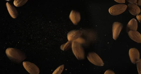 Almonds falling from below, slowmotion low angle 4K pro res Video stock 275897363