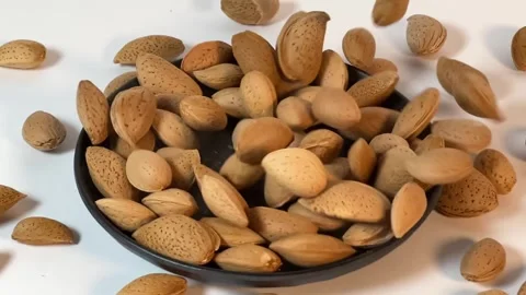 Almonds falling into a bowl in slow motion, 16:9 horizontal video Vídeos de archivo 336471038