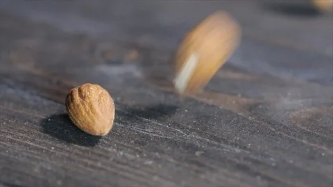 Almonds Falling on Wooden Table Closeup 動画素材 99163782