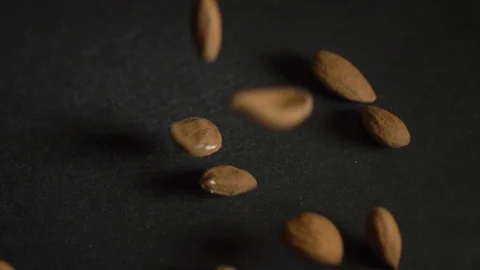 Almonds falls on a black background 스톡 동영상 106707739