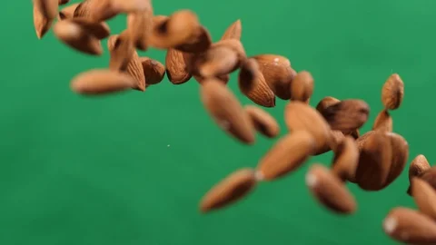 Almonds fly up and down on a green background.Cooking healthy food with almonds. Stock Footage 127916784