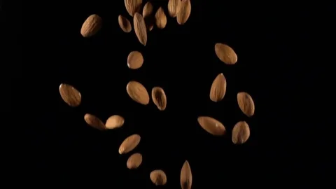 Almonds in free fall on a black background Stock Footage 71461185