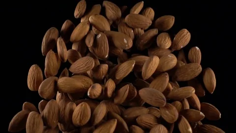 Almonds in free fall on a black background Stock Footage 71461341
