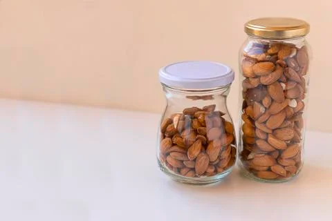 Almonds freshly caught in two cans with white background. Stock Photos