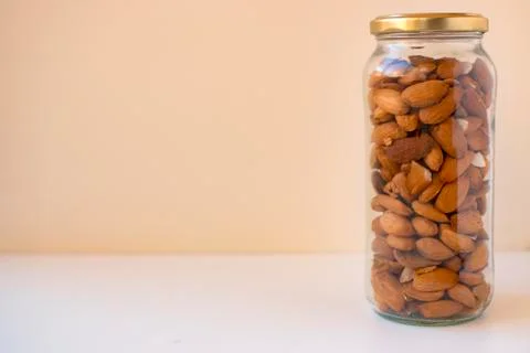 Almonds freshly caught in two cans with white background. Stock Photos