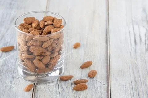 Almonds in a glass Stock Photos