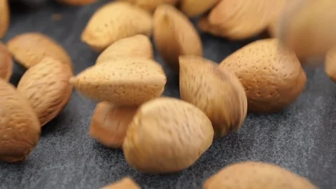Almonds on gray stone background, slow motion, close-up Vídeos de archivo 87710429