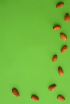 Almonds on a green background, empty space Stock Photos