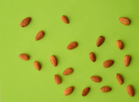 Almonds on a green background Stock Photos