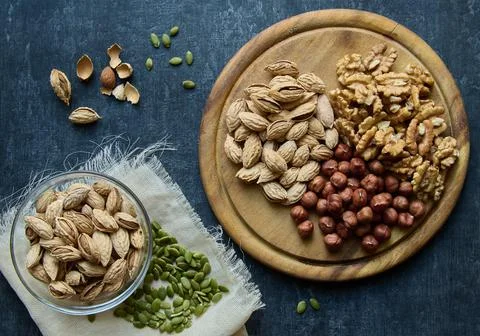 Almonds, hazelnuts, walnuts and pumpkin seeds, top view, flat lay, healthy di Stock Photos