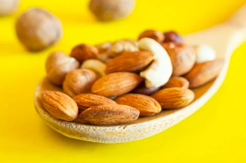 Almonds, Hazelnuts, Walnuts, Cashew Nuts in a Wooden Spoon Stock Photos