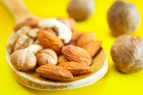 Almonds, Hazelnuts, Walnuts, Cashew Nuts in a Wooden Spoon Stock Photos