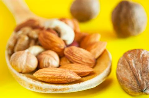 Almonds, Hazelnuts, Walnuts, Cashew Nuts in a Wooden Spoon Stock Photos