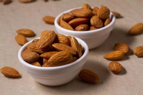 Almonds isolated on light background. Flat lay Stock-Fotos