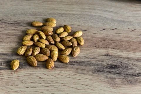 Almonds lying on the table by the handful Stock Photos
