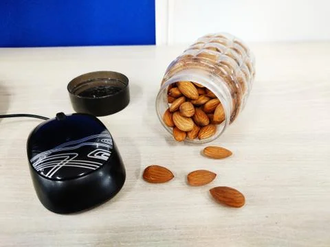 Almonds nut on office Table and in transparent box for healthy snacks diet plan Stock Photos