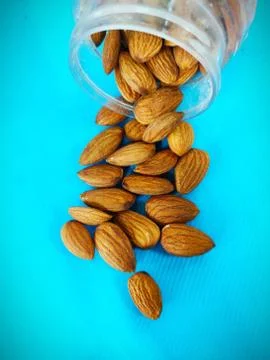 Almonds nut on Table and in transparent box light colour background with space Stock Photos