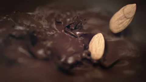 Almonds Nuts Falling Into Liquid Chocolate in 4K Super slow motion Stock Footage 138710005