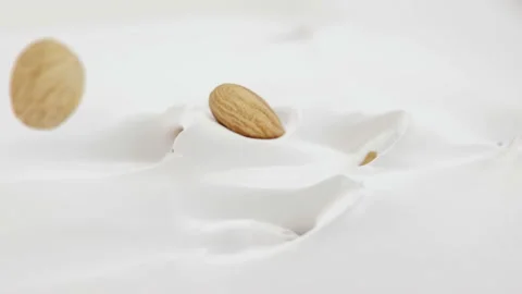 Almonds Nuts Falling Into Liquid Yoghurt in 4K Super slow motion Stock Footage 136352693