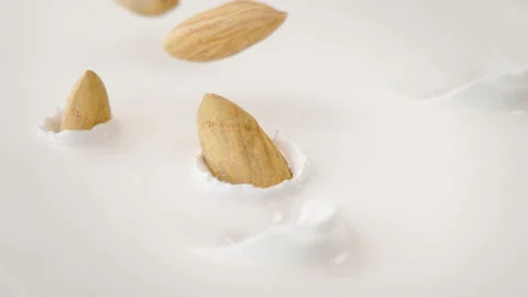 Almonds Nuts Falling Into Milk in 4K Super slow motion Stock Footage 138709699