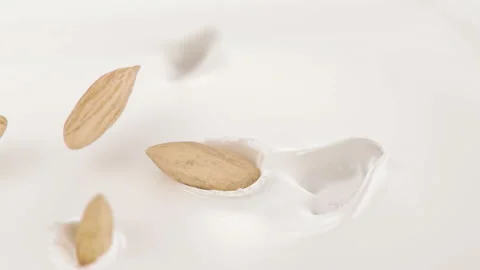 Almonds Nuts Falling Into Milk in 4K Super slow motion Stock Footage 138712529