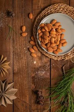 Almonds nuts on a plate placed on a rustic wooden board. Delicious sweet al.. Stock Photos