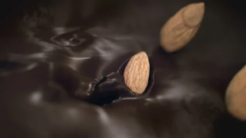 Almonds Nuts Splash Into Liquid Chocolate in 4K Super slow motion Stock Footage 136213510