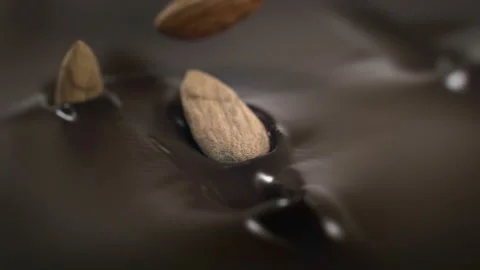 Almonds Nuts Splash Into Liquid Chocolate in 4K Super slow motion Stock Footage 136241207