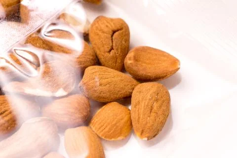 Almonds packages in plastic packaging on white Stock Photos