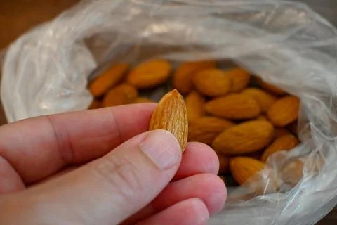 Almonds in Plastic Bag Close-Up, Raw Food Storage Concept Fotos Stock