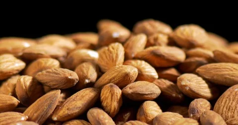 Almonds rotating on black background close-up Stock Footage 122051421