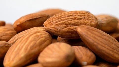 Almonds rotating close-up on white background Stock Footage 105585991