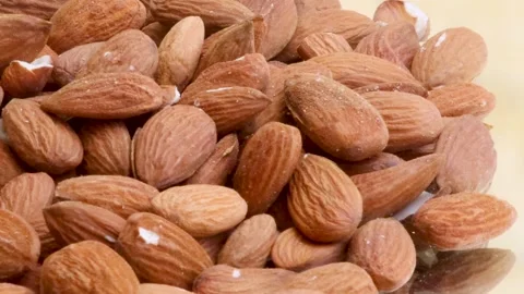 Almonds rotating slowly on a surface Stock Footage 338160888