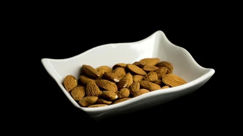 Almonds Rotating on White Plate Close Up Video stock 329966400