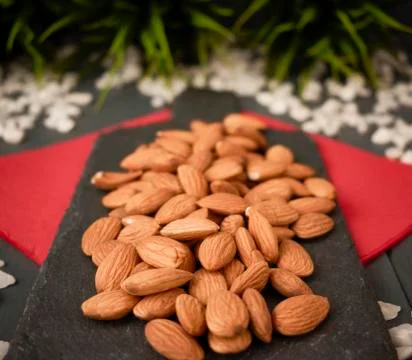 Almonds on a slate table as a snack Stock Photos