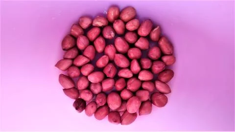 Almonds with space for text in pink background Stock Photos